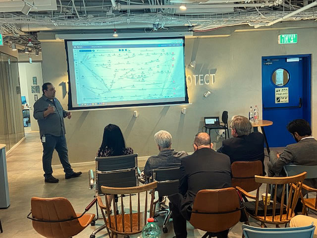 Here the delegation listens to a presentation by the founder of CYE Reuven Aronashvili. CYE offers nation-state-grade offensive cyber security capabilities for defensive purposes, helping customers understand the most likely attack vectors into their organization’s Crown Jewels.
